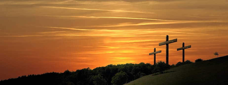 A sunset behind three crosses on Calvary